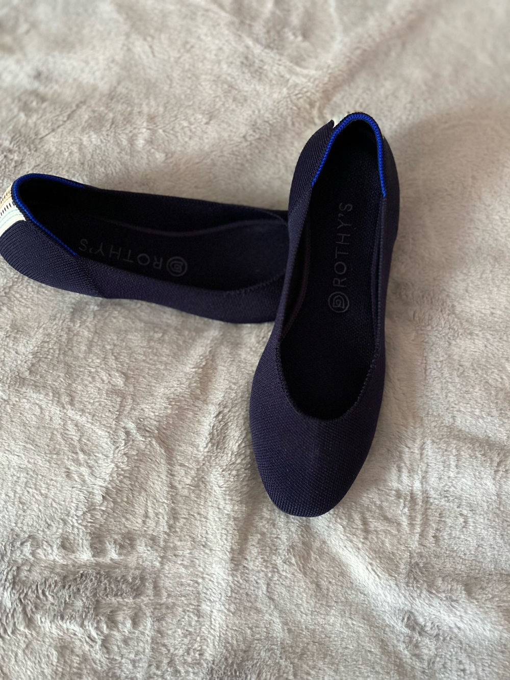 Rothy’s The Flat round toe dark blue with heel stripes